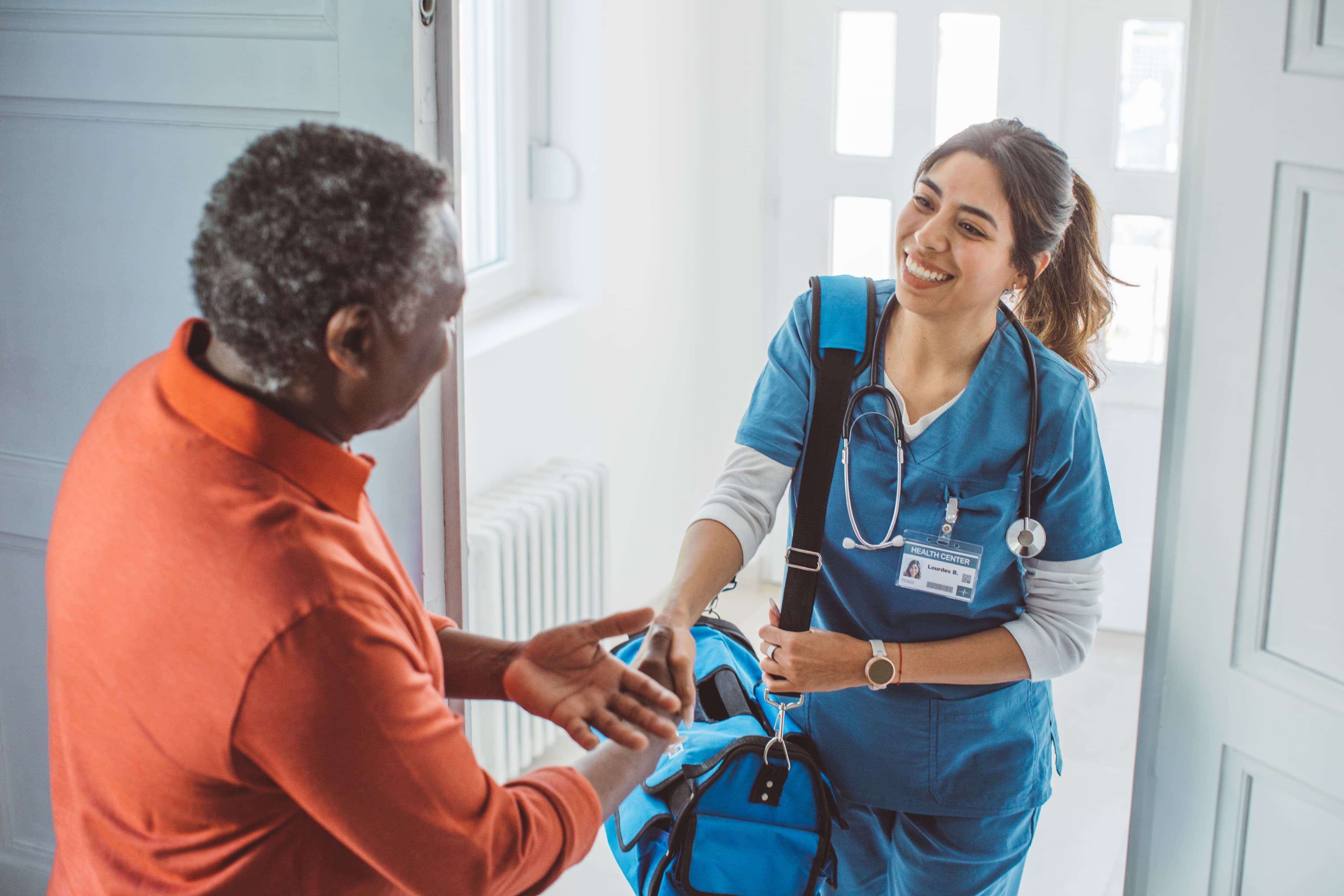 A Leap Care Guide speaking with a patient at home